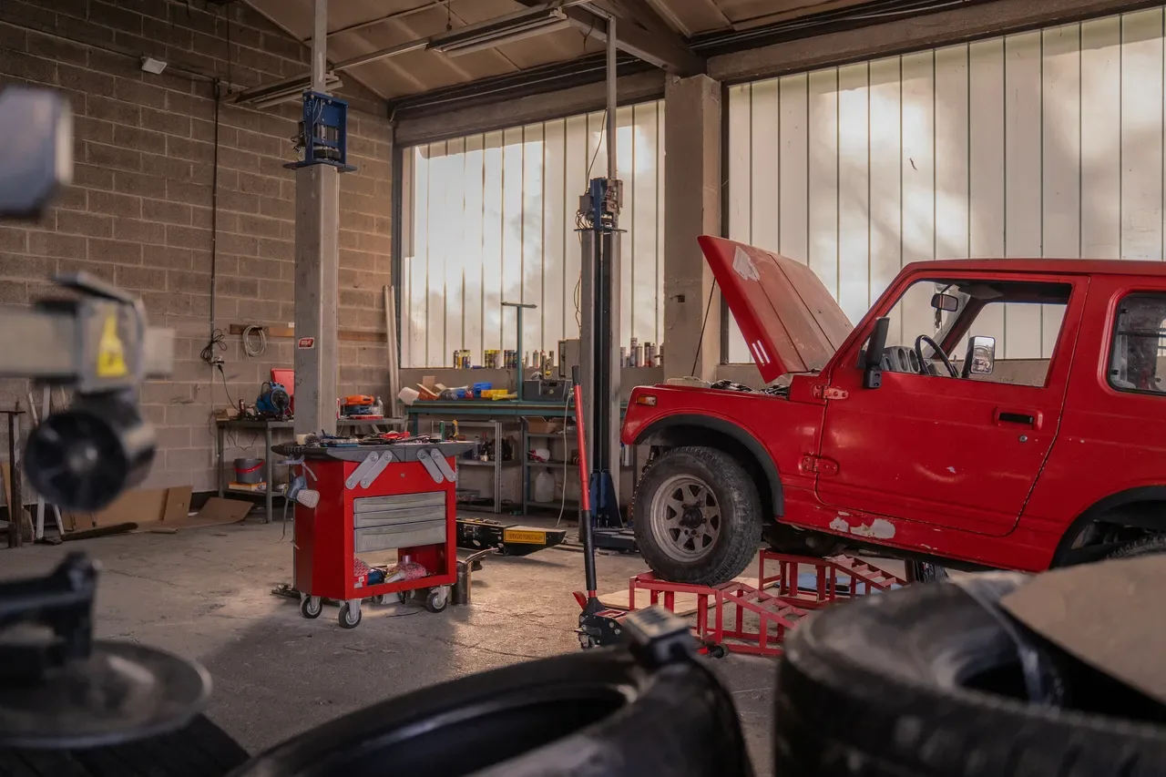 Inside the NW Sprinter Services shop floor in Woodland, WA — a customer vehicle on the lift in golden afternoon light